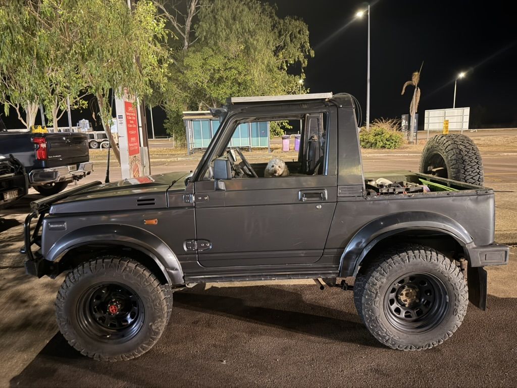 Our open-top Suzuki parked outside a country pub at night